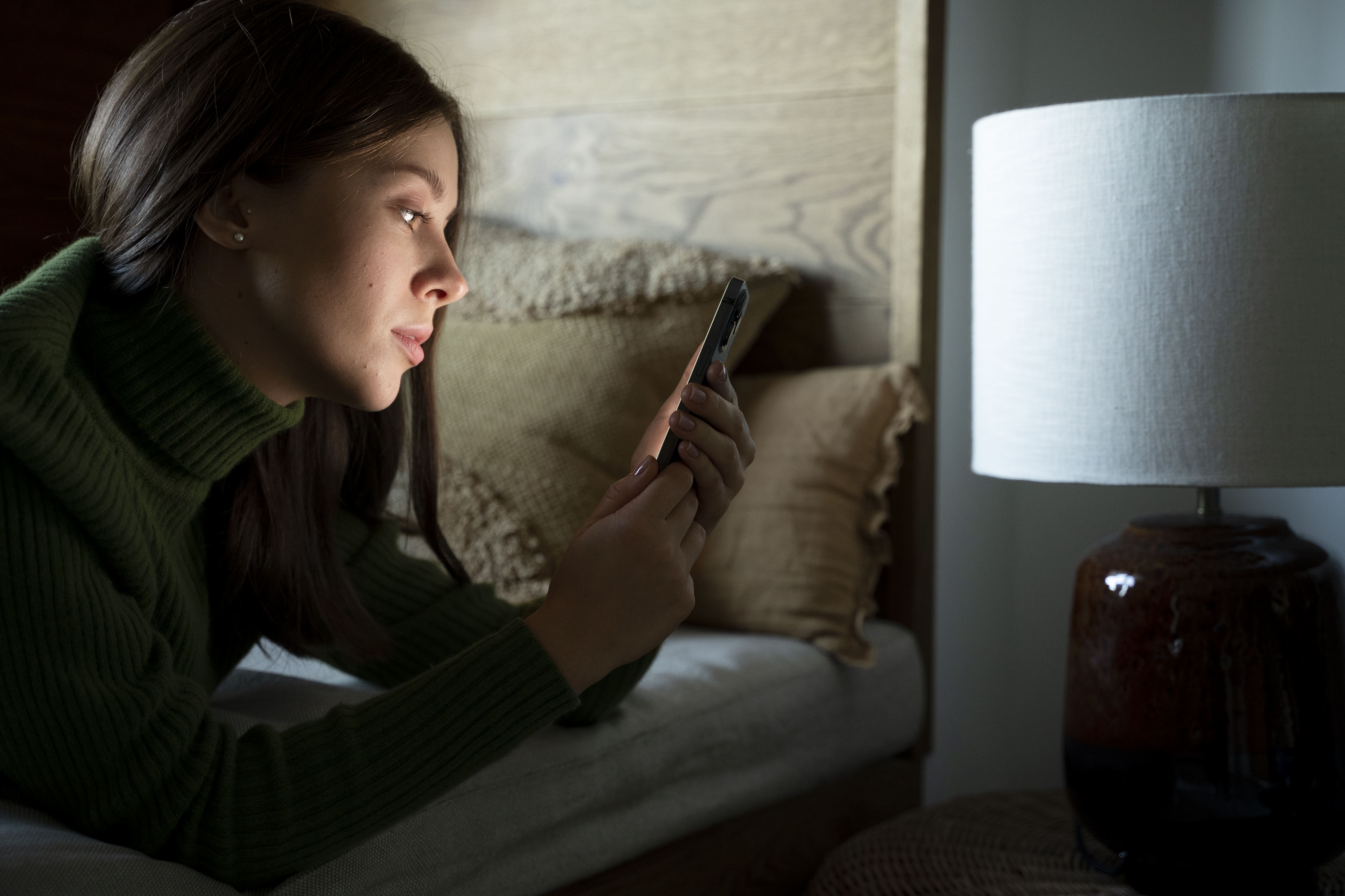 woman-laying-bed-while-looking-her-smartphone (1).jpg